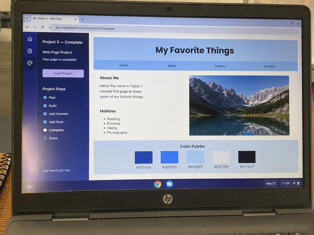 Laptop screen showing a simple student digital project marked complete